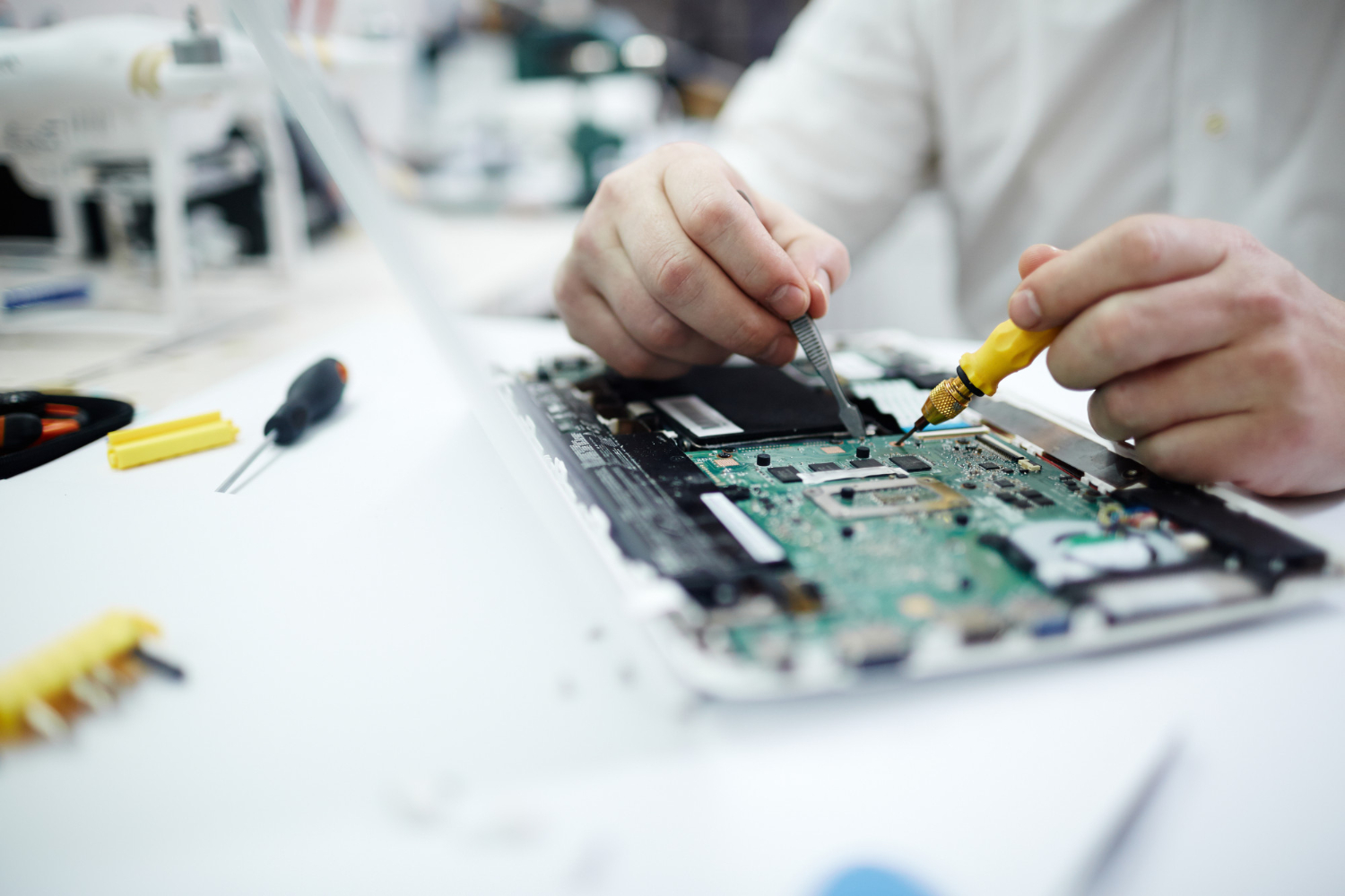 man-repairing-circuit-board-laptop